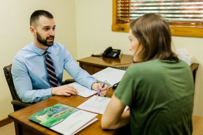 man and woman at desk - Intake at at St. Joseph Institute for Addiction