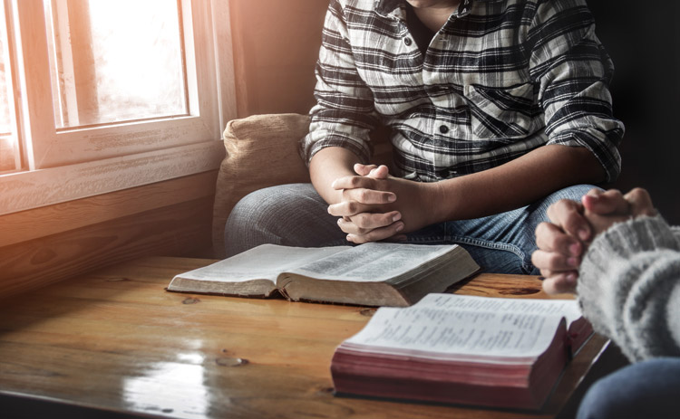 two men holding bible study - spirituality